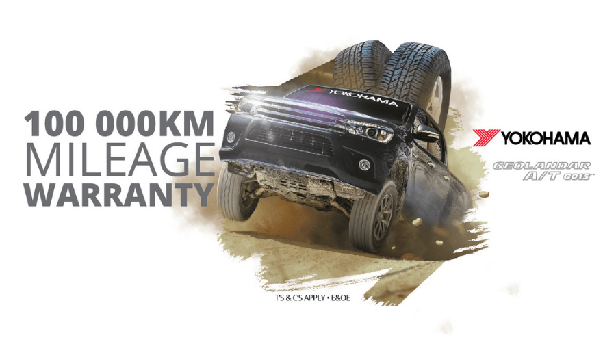 Yokohama 100,000km mileage warranty promotion banner: Truck leaping over offroad terrain.
